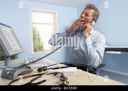 General practitioner at work in his office. Stock Photo