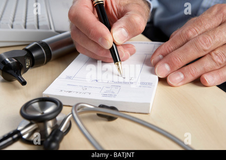 Prescription. General practice doctor writing a prescription. Stock Photo