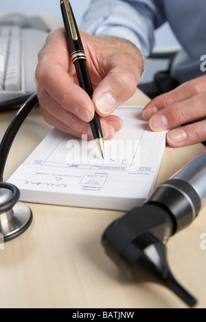 Prescription. General practice doctor writing a prescription. Stock Photo