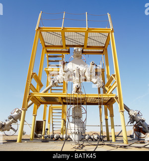 Christmas tree assembly. An array of pipes and valves fitted to a production wellhead. Stock Photo