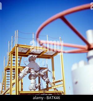 Christmas tree assembly. An array of pipes and valves fitted to a production wellhead. Stock Photo