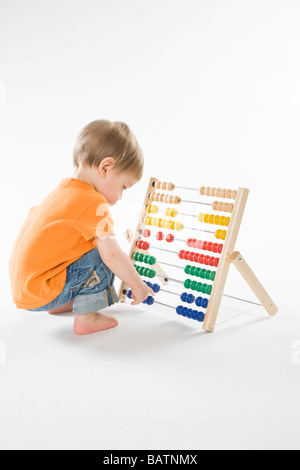 baby playing with abacus Stock Photo