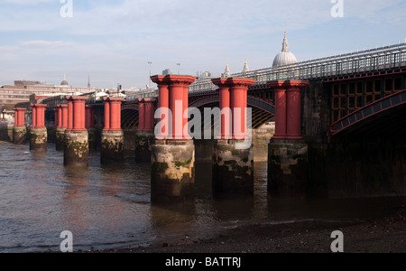 Blackfriars Railway Bridge with the Pillars of the Old Bridge across the River Thames, St.Pauls Cathedral in the background Stock Photo