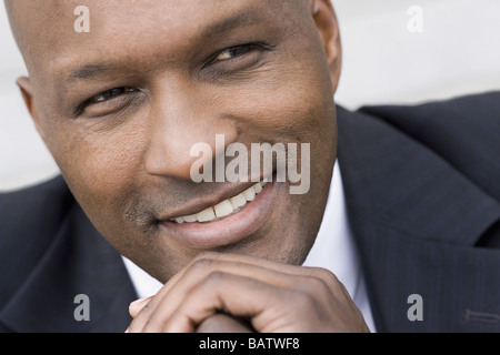 Close-up of businessman smiling, studio shot Stock Photo