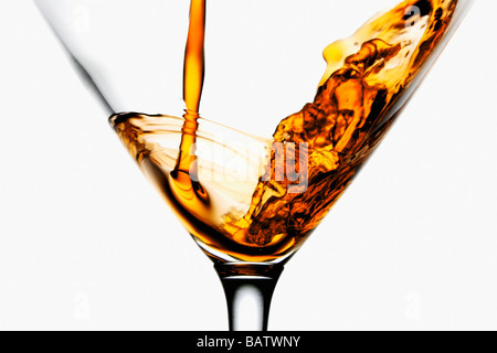 Drink being poured into wineglass, close-up Stock Photo