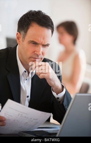 Successful mature businessman working in office Stock Photo