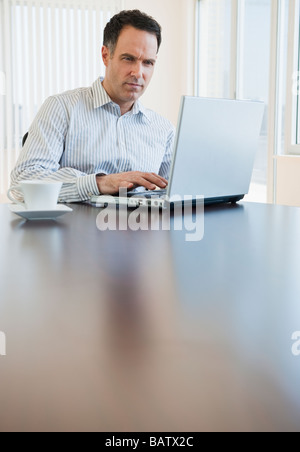 Mature businessman using laptop Stock Photo