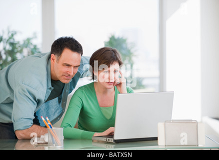Couple using laptop Stock Photo