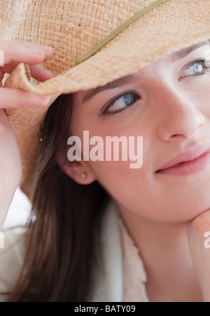 Pensive young woman wearing hat Stock Photo