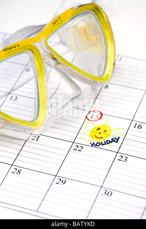 still life of diving goggles with holidays marked in calendar Stock Photo