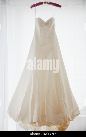 Wedding dress on hanger, studio shot Stock Photo