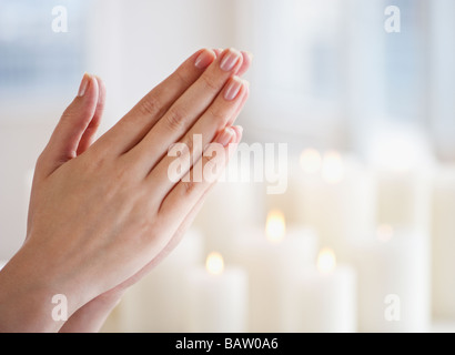 Woman praying, close-up of hands Stock Photo