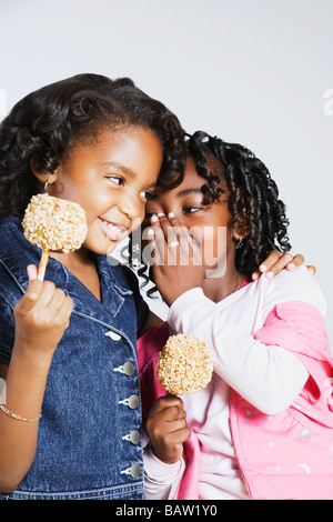 African girls whispering secrets Stock Photo