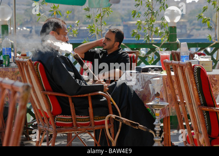 Man smoking a Shisha in a shisha bar, Dubai, UAE Stock Photo