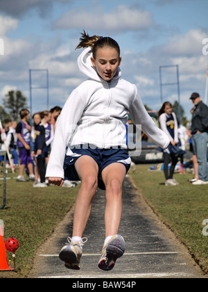 A middle school girl s long jump at a track and field meet in Bend Oregon Stock Photo