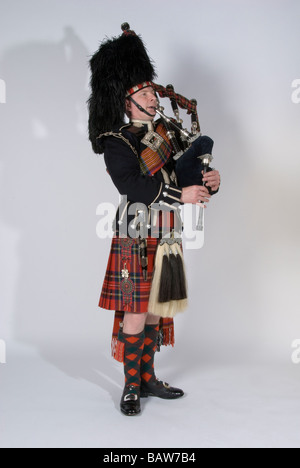 Bagpiper in Full Scottish Highland Dress Stock Photo