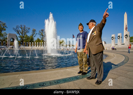 US Navy veteran points out details of the World War II Memorial to his Vietnam War veteran son in Washington DC Stock Photo