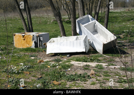 old fridge freezers dumped in field in countryside Stock Photo
