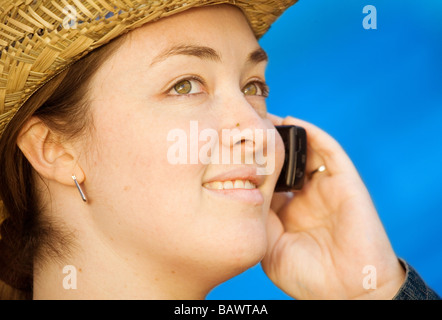 casual woman wearing a hat on the phone Stock Photo