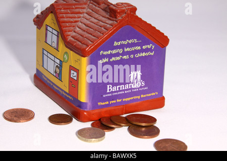 Barnardos charity collection box in the shape of a house used for children to collect small change for the charity Stock Photo