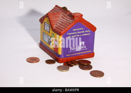 Barnardos charity collection box in the shape of a house used for children to collect small change for the charity Stock Photo