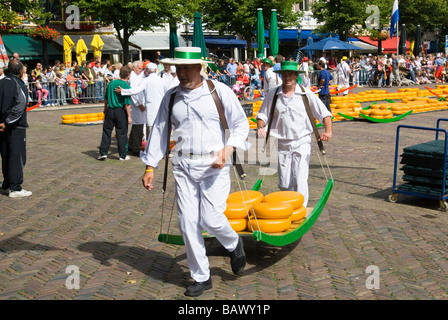 Two Men Carry Gouda Cheese in Alkmaar Stock Photo