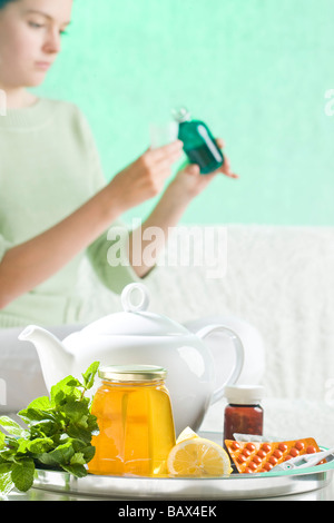 woman taking syrup Stock Photo