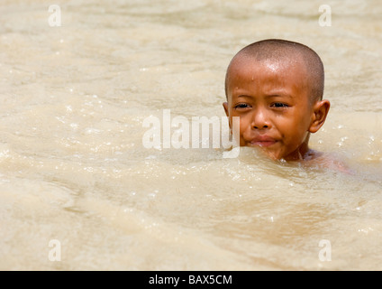 A young boy swimming in the Bogale river after cyclone Nargis struck Myanmar between the 2nd and 3rd of May 2008 Stock Photo