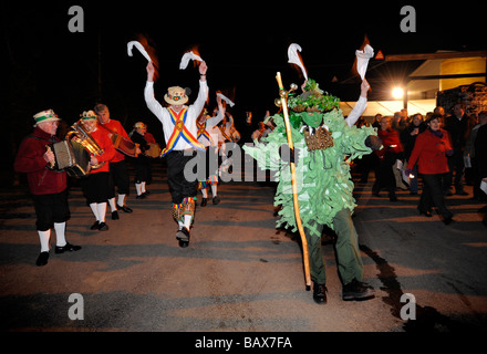 Green Man and Mendip Morris Men lead the Wassailing Procession during Thatchers Cider Wassailing event Stock Photo