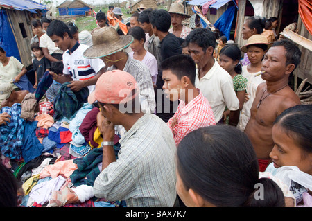 Survivors wait for relief to be delivered near Bogale after Cyclone Nargis struck Myanmar between the 2nd and 3rd of May 2008 an Stock Photo