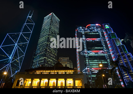 The Bank of China Tower, Cheung Kong Center, HSBC Main Building and Hong Kong City Hall in the forground at Night. Stock Photo