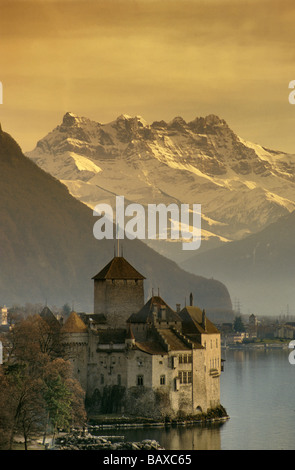 Chateau de Chillon at Lake Geneva with Bernese Alps in distance in Vaud canton Switzerland Stock Photo