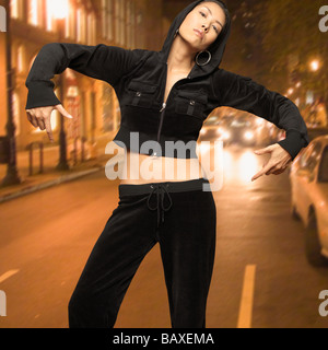 Asian woman posing in street Stock Photo