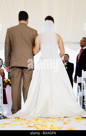 Bride being walked down aisle Stock Photo
