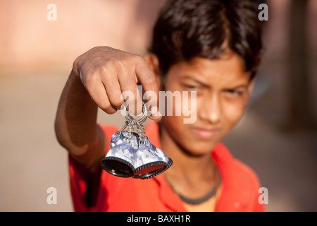 Boy Selling Souvenir Taj Mahal Keychains Outside of the Taj Mahal in Agra India Stock Photo