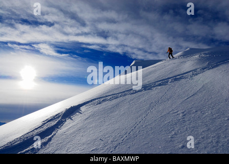 backcountry skiier on ridge with cornices and ski tracks, Kuehgundkopf ...