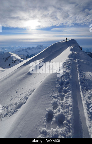 backcountry skiier on ridge with cornices and ski tracks, Kuehgundkopf ...