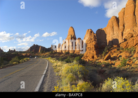 Road among freakish natural stone formations in the well known park Arches in the USA Stock Photo