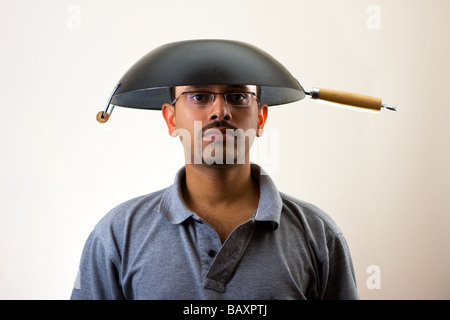 Man with Wok on head isolated on white Stock Photo