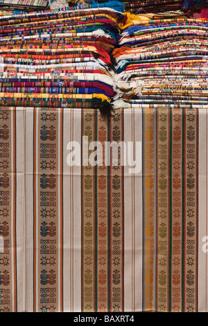 Brightly coloured locally woven fabrics at the famous market in Otavalo Imbabura Province Northern Highlands Ecuador Stock Photo