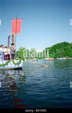 People driving in boats during a procession on lake Staffelsee, Murnau, Bavaria, Germany Stock Photo