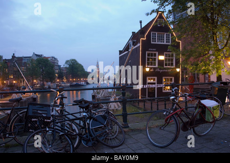 Bicycles, de Sluyswacht, Oude Schans, Bicycles in front of de Sluyswacht, a brown cafe, in the evening, Oude Schans, Amsterdam, Stock Photo