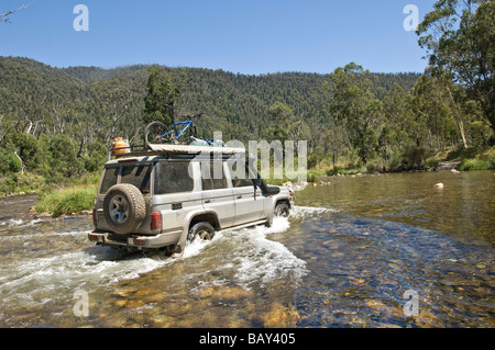 Four wheel drive car crossing Swampy Plains Creek Geehi Valley Kosciuszko National Park New South Wales Australia Stock Photo