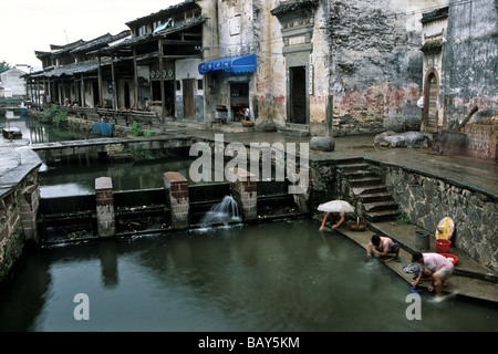 Women doing their laundry in a small dam at the village Tangmo, Huang Shan, China, Asia Stock Photo