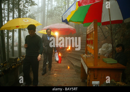 Pilgrims in the rain on the pilgrimage route, Jiuhua Shan, Anhui province, China, Asia Stock Photo