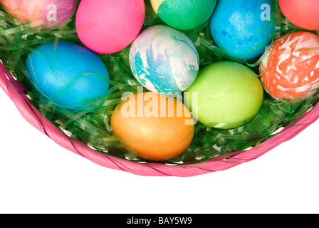 A group of colorful, decorated Easter eggs in a basket of green grass Stock Photo