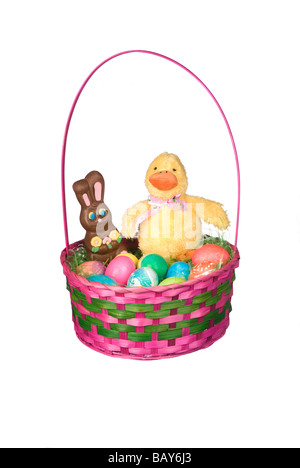An Easter basket with colored eggs a chocolate bunny and a stuffed toy chicken Stock Photo