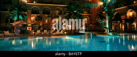 The illuminated pool of Hotel Ritz Carlton at night, Dubai, United Arab Emirates Stock Photo