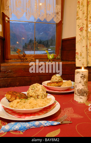 laid table with two portions of Tyrolean Kaspressknoedel and Speckknoedel with sauerkraut, Tyrol, Austria Stock Photo
