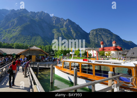 people on landing stage with boat, Watzmann range in background, St. Bartholomae, lake Koenigssee, Berchtesgaden range, National Stock Photo